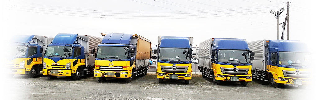 群馬県藤岡市の運送会社|鬼石運輸株式会社|鬼石運輸カラーのトラックが並んでいる写真